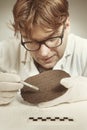 Archaeologist researcher taking samples of cuneiform material Royalty Free Stock Photo
