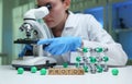 A scientist observing protons through a microscope in a lab for research and discovery Royalty Free Stock Photo