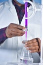 Scientist Performing titration experiment with color solution in chemistry Lab Royalty Free Stock Photo