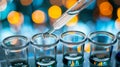 Scientist pipette dropping liquid test tubes bokeh background. Scientific research, laboratory work