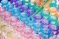 Scientist pipetting a DNA sample into a vials in rack