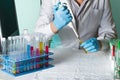 Scientist pipetting sample for study in tube Royalty Free Stock Photo