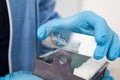 Scientist placing slides with paraffin embedded tissue samples into a slide staining rack. Fluorescent Immunohistochemistry