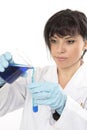 Scientist pouring blue liquid