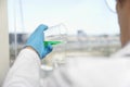 Scientist Pouring Green Liquid Into Beaker