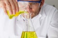 Scientist Pouring Liquid Into Flask