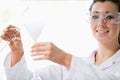 Scientist pouring liquid with a funnel Royalty Free Stock Photo