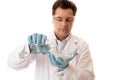 Scientist pouring liquid into petri dish