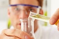 Scientist Pouring Liquid From Test Tube Into Flask Royalty Free Stock Photo