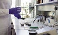 The scientist pouring water in graduated cylinder Royalty Free Stock Photo