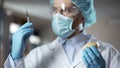 Scientist preparing syringe for adding pesticides and nitrates in potato sample