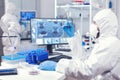 Scientist in protection suit holding sample of infected blood with coronavirus