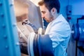 Scientist with protective robber gloves for handling dangerous substances in sterile environment