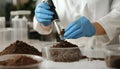 Scientist pulverizing and sieving soil samples at table, closeup. Laboratory analysis Royalty Free Stock Photo