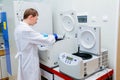 Scientist puts samples into centrifuge device