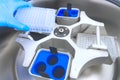 Scientist puts the test tubes in centrifuge. Automation in the clinical laboratory. Pipetting robot laboratory. Research and