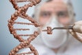Scientist is replacing part of a DNA molecule. Genetic engineering and gene manipulation concept