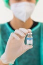 Scientist or reseacher holding coronavirus covid-19 vaccine bottle