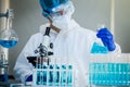 Scientist or researcher hand in blue gloves holding flu, measles, coronavirus, covid-19 vaccine disease