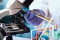 Scientist Researcher working with biologic sample tube and microscope in biotechnology lab Royalty Free Stock Photo