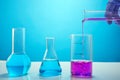 Scientist`s hand pours liquid into test tubes for chemical research Royalty Free Stock Photo