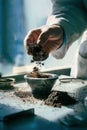 A scientist's hands carefully crushing and sifting a dry soil sample for lab analysis Royalty Free Stock Photo