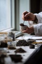 A scientist's hands carefully crushing and sifting a dry soil sample for lab analysis Royalty Free Stock Photo