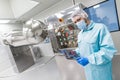 Scientist stand near control panel with buttons