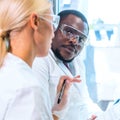 Scientist and students working in lab. Doctor teaching interns to make blood analyzing research. Coronavirus, chemistry Royalty Free Stock Photo