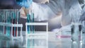 Scientist taking drops of liquids to check chemical reaction at research lab Royalty Free Stock Photo