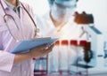 Scientist Taking notes in the laboratory and scientific equipment In the laboratory,Laboratory research concept,science background Royalty Free Stock Photo