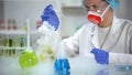 Scientist taking yellow liquid sample in pipette and checking sediment, petrol