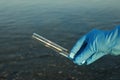 Scientist with test tube taking sample from river for analysis, closeup Royalty Free Stock Photo