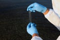 Scientist with test tube taking sample from river for analysis, closeup Royalty Free Stock Photo