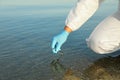 Scientist with test tube taking sample from river for analysis, closeup Royalty Free Stock Photo