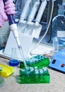 Scientist with test tubes and flasks conducting an experiment in a science lab Royalty Free Stock Photo