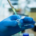 Scientist with test tubes and flasks conducting an experiment in a science lab Royalty Free Stock Photo