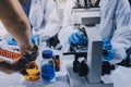Scientist using microscope in laboratory. Close-up of a researcher& x27;s hands adjusting microscope in lab setting. Scienc Royalty Free Stock Photo