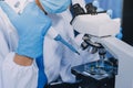 Scientist using microscope in laboratory. Close-up of a researcher& x27;s hands adjusting microscope in lab setting. Scienc Royalty Free Stock Photo
