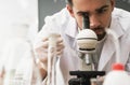 Scientist is using microscope in a laboratory during research Royalty Free Stock Photo