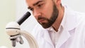 Scientist is using microscope in a laboratory during research Royalty Free Stock Photo