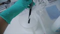 Scientist using protective gloves for handling dangerous substances and experiments. Clip. Testing of the substance in