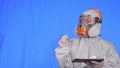 Scientist virologist in respirator makes write in an tablet computer with stylus. Woman wearing protective medical mask