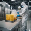 A scientist wearing a hazmat suit while handling a sample in a highly secure containment facility3