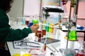 Scientist were fully engrossed in experiments, her focus unwavering as she worked diligently on a table.