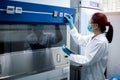 Scientist woman checking the fume hood in the laboratory