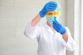 Scientist woman with equipment and laboratory glassware holding chemical liquid and checking result using as science research Royalty Free Stock Photo