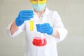 Scientist woman with equipment and laboratory glassware holding chemical liquid and checking result using as science research Royalty Free Stock Photo