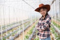 Scientist woman and farmer check melon fruit quality