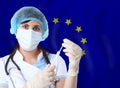 Scientist woman with test tube Coronavirus or COVID-19 against The European Union flag. Research of viruses in laboratory Royalty Free Stock Photo